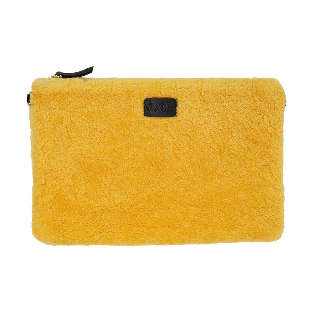 Lovelies Studio Wujii is a large shearling clutch which has room enough for your Ipad and notebooks . Wujii is hand made from the finest curly shearling from Australia.  Top zipped closing   Detachable wrist strap   Satin lining and flat zipped inner pocket   Item comes with a branded dust bag.   Embossed Lovelies logo on the front   Gold-toned hardware   Measurements W34 X D2 X H22 cm   100 % Australian curly shearling 