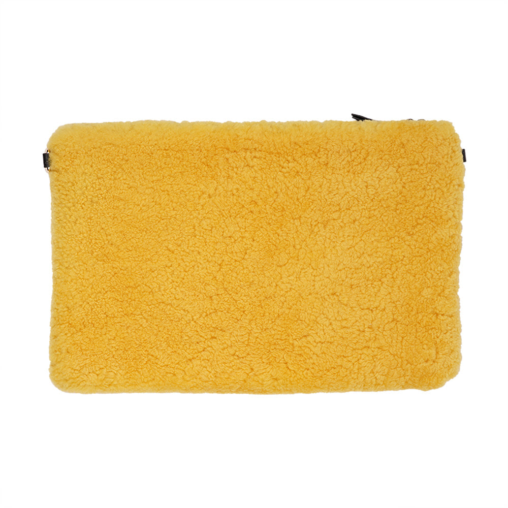 Lovelies Studio Wujii is a large shearling clutch which has room enough for your Ipad and notebooks . Wujii is hand made from the finest curly shearling from Australia.  Top zipped closing   Detachable wrist strap   Satin lining and flat zipped inner pocket   Item comes with a branded dust bag.   Embossed Lovelies logo on the front   Gold-toned hardware   Measurements W34 X D2 X H22 cm   100 % Australian curly shearling