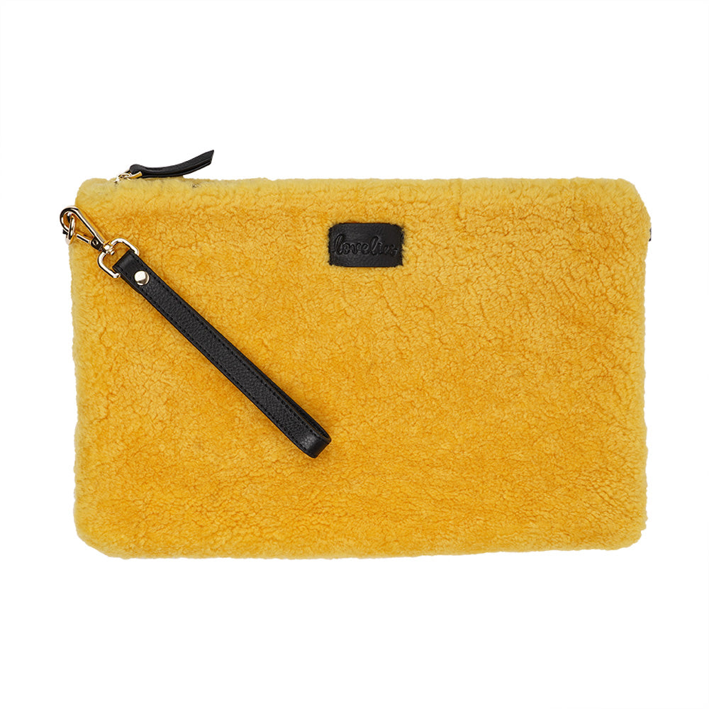 Lovelies Studio Wujii is a large shearling clutch which has room enough for your Ipad and notebooks . Wujii is hand made from the finest curly shearling from Australia.  Top zipped closing   Detachable wrist strap   Satin lining and flat zipped inner pocket   Item comes with a branded dust bag.   Embossed Lovelies logo on the front   Gold-toned hardware   Measurements W34 X D2 X H22 cm   100 % Australian curly shearling