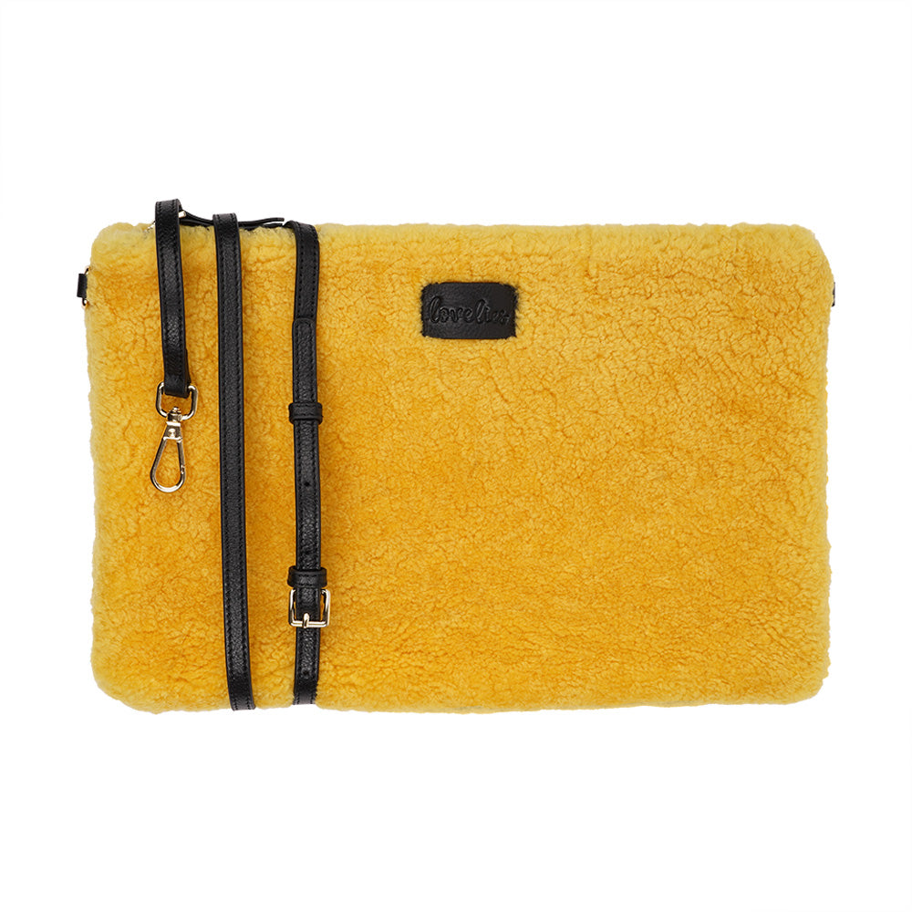 Lovelies Studio Wujii is a large shearling clutch which has room enough for your Ipad and notebooks . Wujii is hand made from the finest curly shearling from Australia.  Top zipped closing   Detachable wrist strap   Satin lining and flat zipped inner pocket   Item comes with a branded dust bag.   Embossed Lovelies logo on the front   Gold-toned hardware   Measurements W34 X D2 X H22 cm   100 % Australian curly shearling