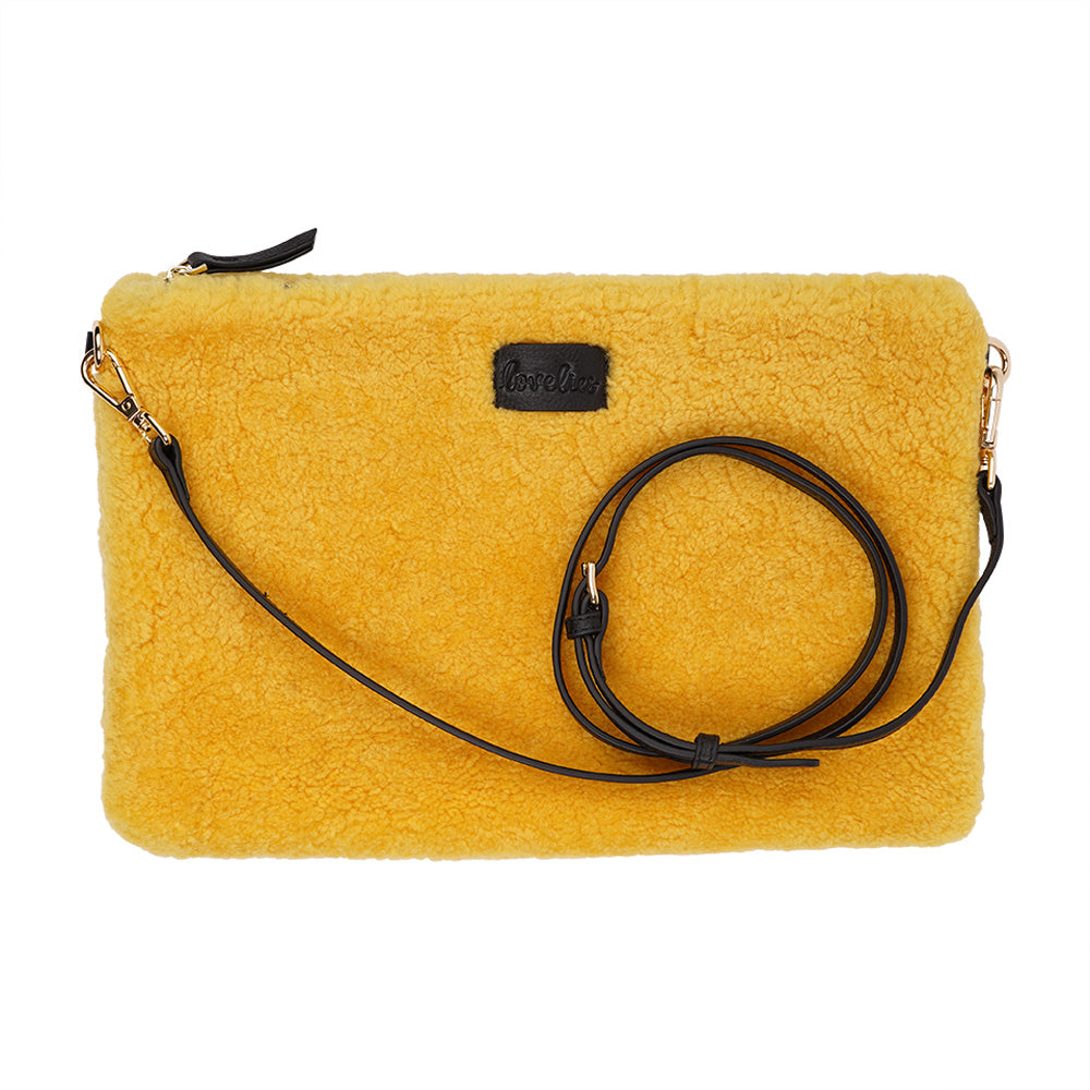 Lovelies Studio Wujii is a large shearling clutch which has room enough for your Ipad and notebooks . Wujii is hand made from the finest curly shearling from Australia.  Top zipped closing   Detachable wrist strap   Satin lining and flat zipped inner pocket   Item comes with a branded dust bag.   Embossed Lovelies logo on the front   Gold-toned hardware   Measurements W34 X D2 X H22 cm   100 % Australian curly shearling