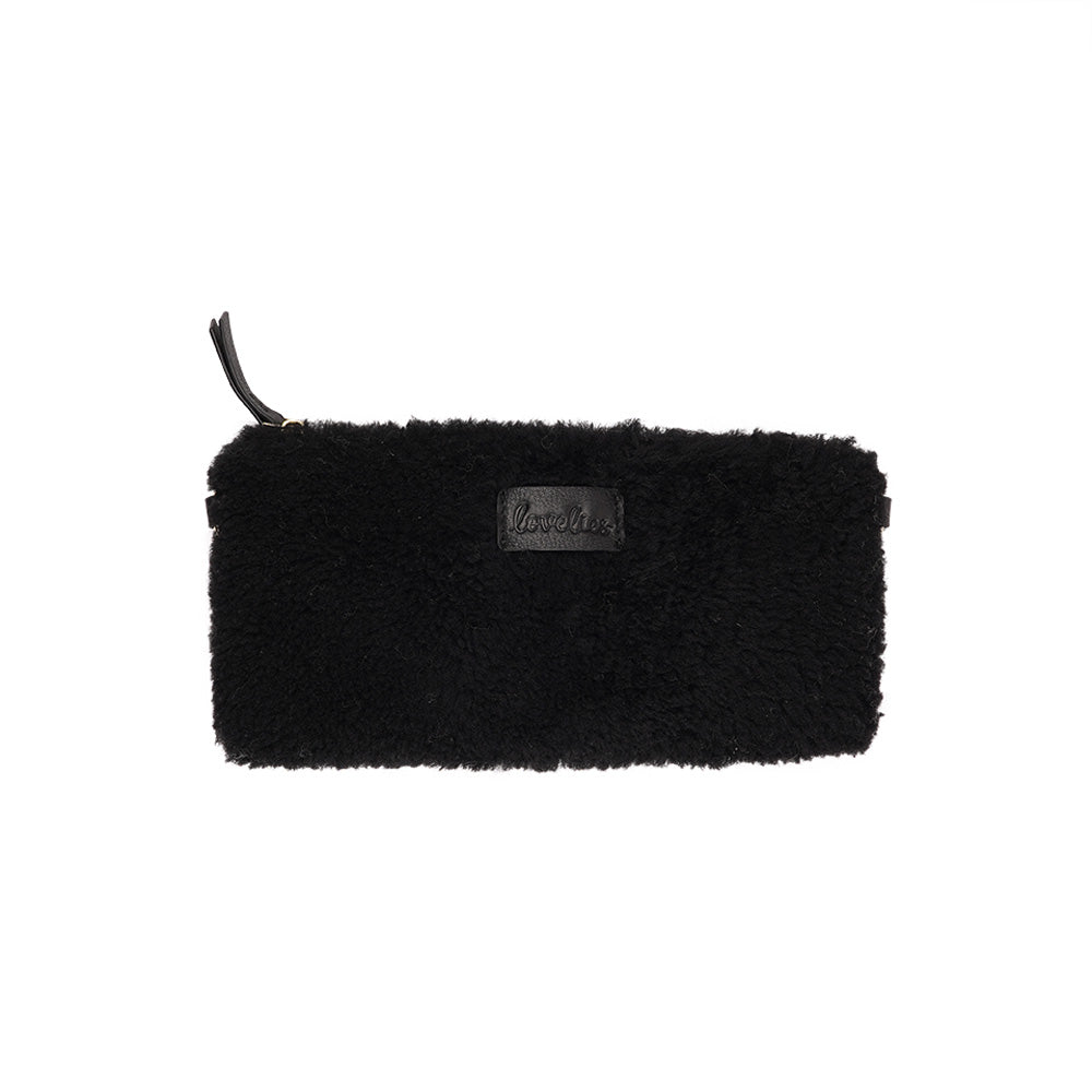 Lovelies Studio _ Wuttu is a mini clutch with a detachable wrist strap and is perfect for carrying your essentials with you. Wuttu is hand made from the finest curly shearling from Australia.   Top zipped closing   Detachable wrist strap   Satin lining and flat zipped inner pocket   Item comes with a branded dust bag.   Embossed Lovelies logo on the front   Gold-toned hardware   Measurements W26 X D2 X H12 cm   100 % Australian curly shearling
