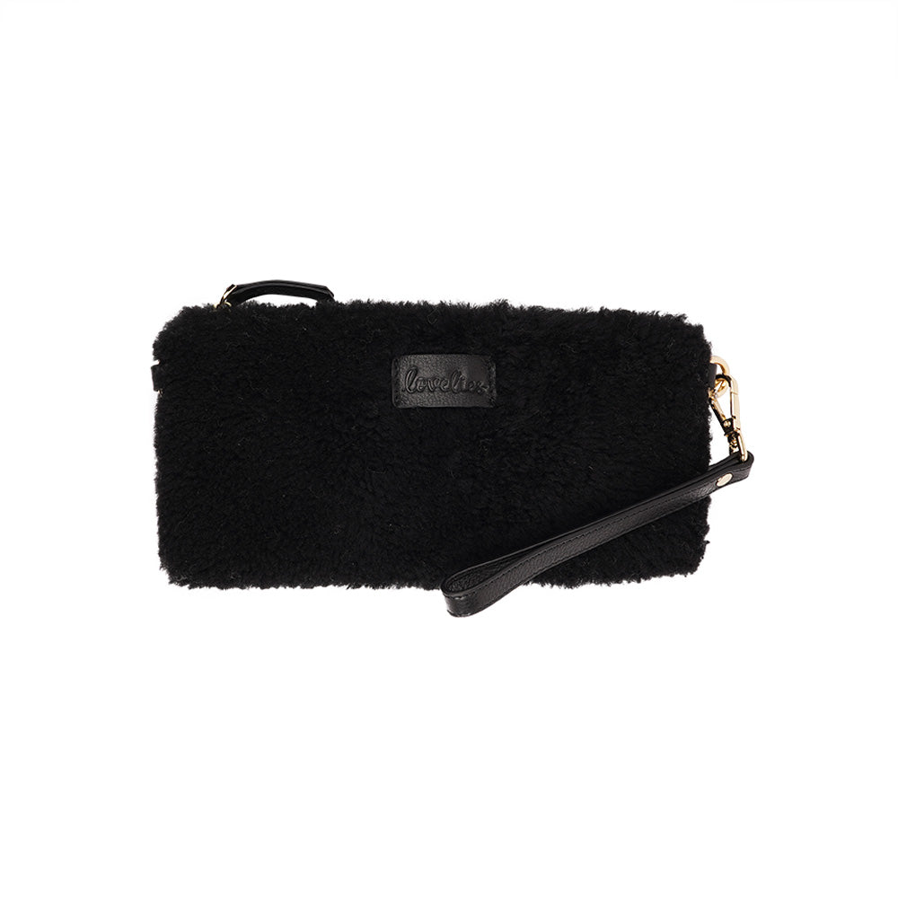 Lovelies Studio _ Wuttu is a mini clutch with a detachable wrist strap and is perfect for carrying your essentials with you. Wuttu is hand made from the finest curly shearling from Australia.   Top zipped closing   Detachable wrist strap   Satin lining and flat zipped inner pocket   Item comes with a branded dust bag.   Embossed Lovelies logo on the front   Gold-toned hardware   Measurements W26 X D2 X H12 cm   100 % Australian curly shearling