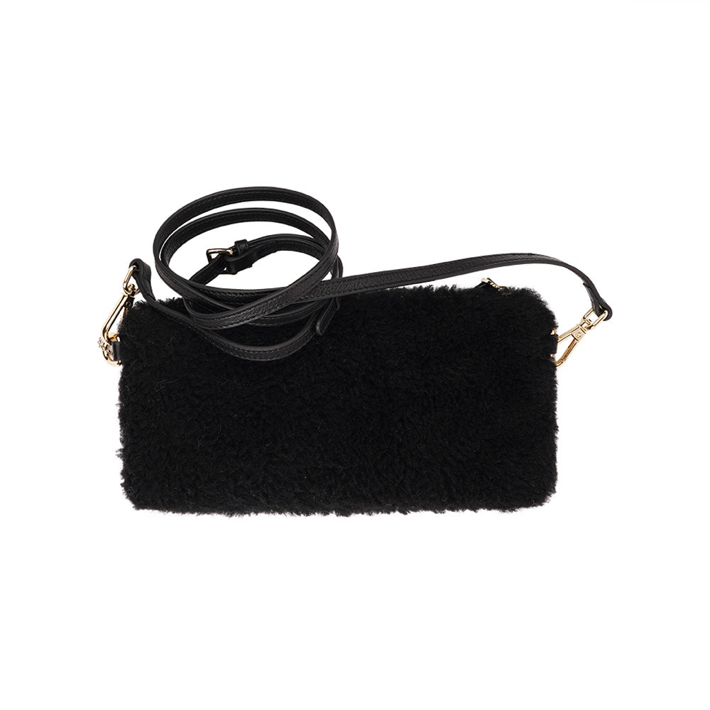 Lovelies Studio _ Wuttu is a mini clutch with a detachable wrist strap and is perfect for carrying your essentials with you. Wuttu is hand made from the finest curly shearling from Australia. Top zipped closing Detachable wrist strap Satin lining and flat zipped inner pocket Item comes with a branded dust bag. Embossed Lovelies logo on the front Gold-toned hardware Measurements W26 X D2 X H12 cm 100 % Australian curly shearling