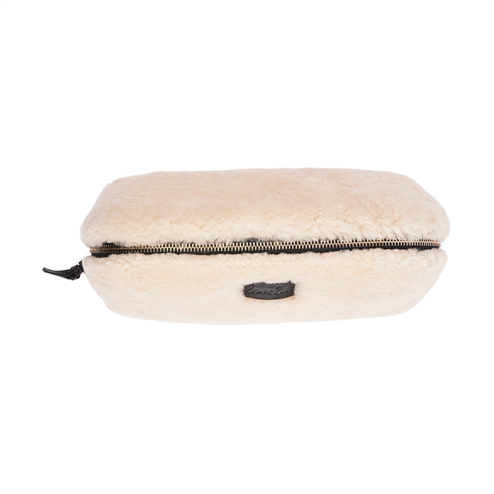 Lovelies Studio - Yadong is a beautiful shearling handbag which is perfect for carrying your essentials with you. Use Yadong as a casual clutch or an exclusive beauty bag for travelling. Top zipped closure. Cream satin lining. Item comes with a branded dust bag. Embossed Lovelies logo on the front. Gold-toned hardware. Measurements W25 X D10 X H13 cm 100 % Australian curly shearling.