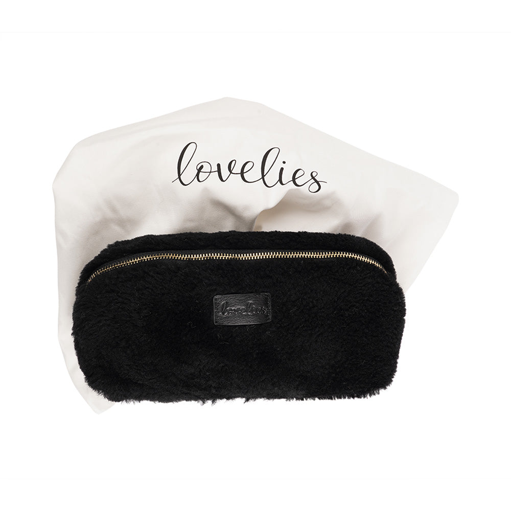 Lovelies Studio - Yadong is a beautiful shearling handbag which is perfect for carrying your essentials with you. Use Yadong as a casual clutch or an exclusive beauty bag for travelling.    Top zipped closure.  Cream satin lining.    Item comes with a branded dust bag.   Embossed Lovelies logo on the front.    Gold-toned hardware. Measurements W25 X D10 X H13 cm  100 % Australian curly shearling.