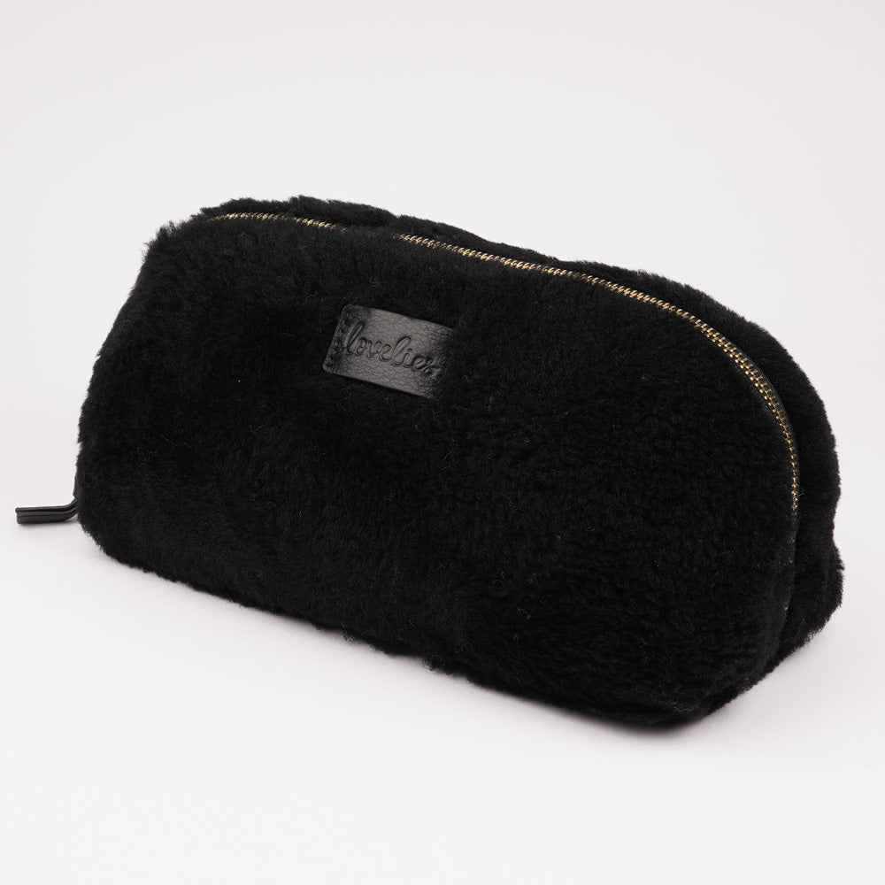 Lovelies Studio - Yadong is a beautiful shearling handbag which is perfect for carrying your essentials with you. Use Yadong as a casual clutch or an exclusive beauty bag for travelling.    Top zipped closure.  Cream satin lining.    Item comes with a branded dust bag.   Embossed Lovelies logo on the front.    Gold-toned hardware. Measurements W25 X D10 X H13 cm  100 % Australian curly shearling.