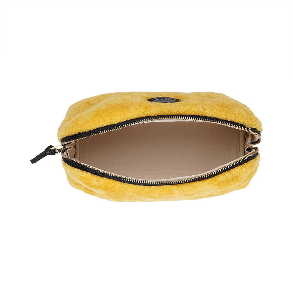 Lovelies Studio - Yadong is a beautiful shearling handbag which is perfect for carrying your essentials with you. Use Yadong as a casual clutch or an exclusive beauty bag for travelling. Top zipped closure. Cream satin lining. Item comes with a branded dust bag. Embossed Lovelies logo on the front. Gold-toned hardware. Measurements W25 X D10 X H13 cm 100 % Australian curly shearling.