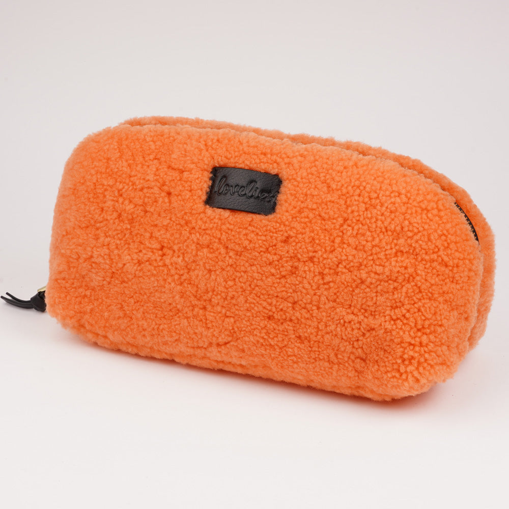 Lovelies Studio - Yadong is a beautiful shearling handbag which is perfect for carrying your essentials with you. Use Yadong as a casual clutch or an exclusive beauty bag for travelling. Top zipped closure. Cream satin lining. Item comes with a branded dust bag. Embossed Lovelies logo on the front. Gold-toned hardware. Measurements W25 X D10 X H13 cm 100 % Australian curly shearling.