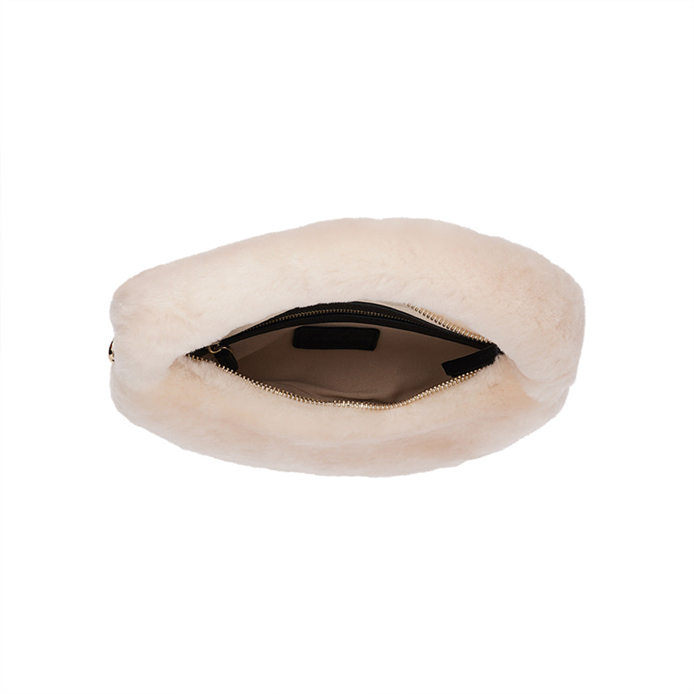 Lovelies Studio - Zhamo is a beautiful small shearling handbag which is perfect for carrying your essentials with you.  * Top handle in thick shearling   * Adjustable and detachable shoulder strap in leather   * Satin lining and flat zipped inner pocket   * Item comes with a branded dust bag.   * Gold-toned hardware   * Messurements W26 X D6 X H24 cm   * 100 % Australian shearling