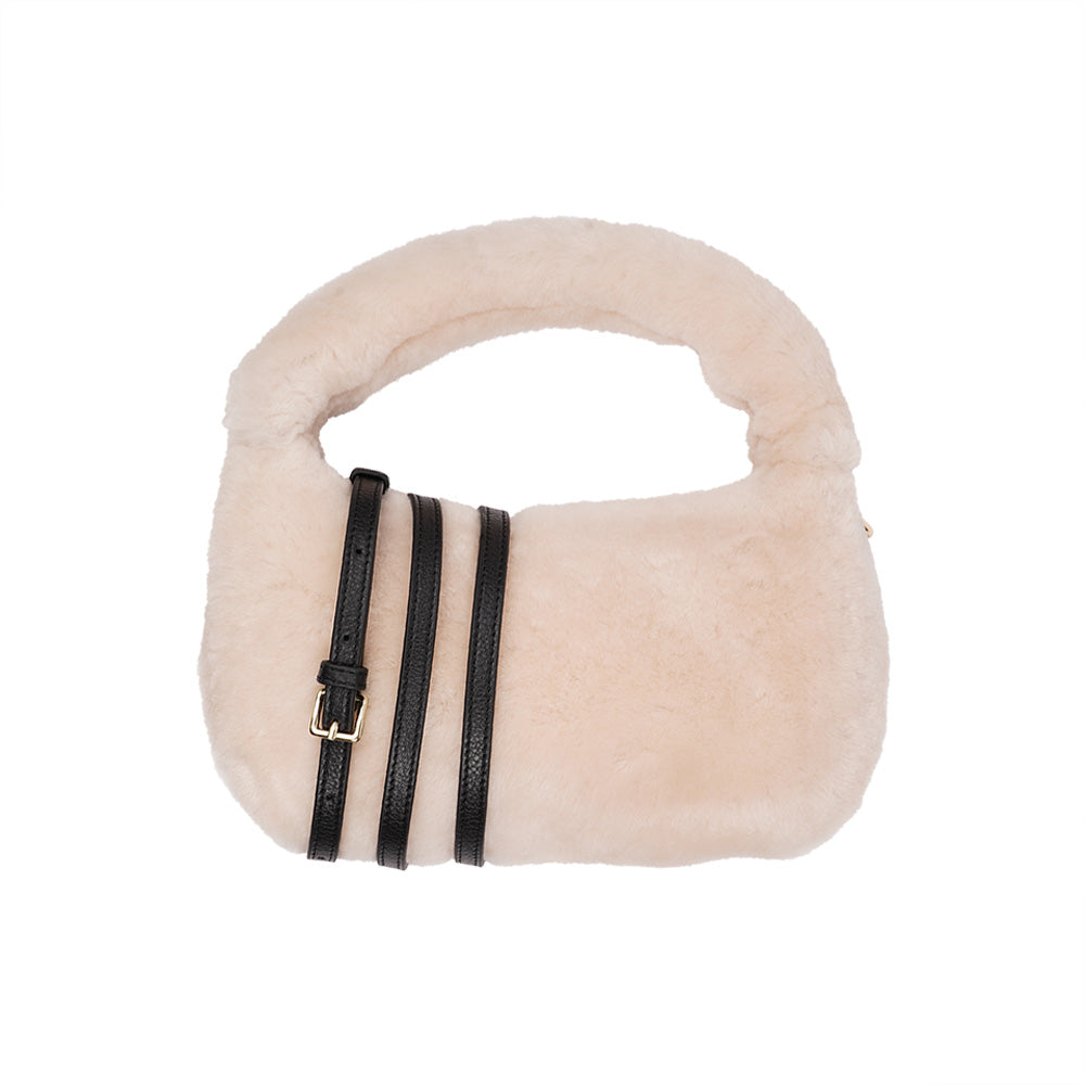 Lovelies Studio - Zhamo is a beautiful small shearling handbag which is perfect for carrying your essentials with you.  * Top handle in thick shearling   * Adjustable and detachable shoulder strap in leather   * Satin lining and flat zipped inner pocket   * Item comes with a branded dust bag.   * Gold-toned hardware   * Messurements W26 X D6 X H24 cm   * 100 % Australian shearling
