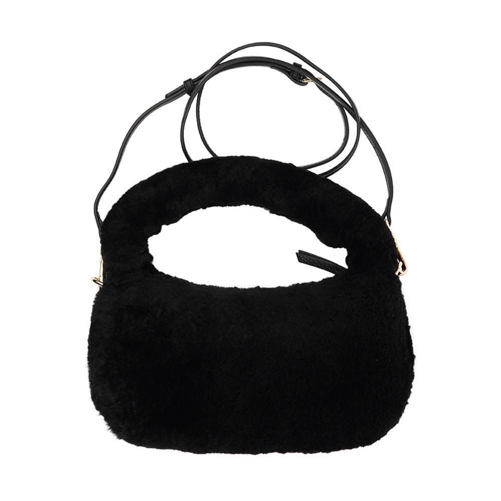 Lovelies Studio - Zhamo is a beautiful small shearling handbag which is perfect for carrying your essentials with you.  * Top handle in thick shearling   * Adjustable and detachable shoulder strap in leather   * Satin lining and flat zipped inner pocket   * Item comes with a branded dust bag.   * Gold-toned hardware   * Messurements W26 X D6 X H24 cm   * 100 % Australian shearling