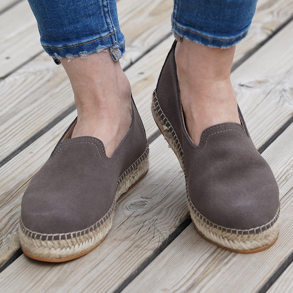 Designed with warm sand hues, our Ballenas Espadrilles bring a touch of elegance to any outfit. The soft and luxurious suede upper not only looks stunning but also provides a cozy and comfortable fit that will have you walking on cloud nine.  Equipped with a durable rubber outsole, these espadrilles are built to withstand various terrains. From sandy beaches to city streets, the reliable traction of the rubber outsole ensures stability and confidence with every step you take.