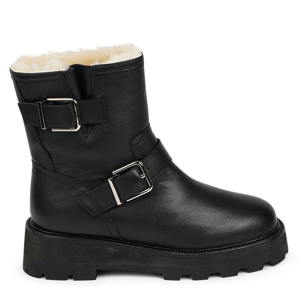 Lovelies Studio - Danish Design - Step into warmth and style this winter with our exquisite Dinara Winter Boot. Crafted to keep you snug and stylish through the coldest months.  The Dinara Winter Boot boasts a robust, thick rubber sole, providing superior traction and durability, so you can confidently navigate snowy streets and icy pathways. The upper is handcrafted in supple nappa leather.   Two adjustable buckles grace the boot's upper, allowing you to personalize the fit to your preference