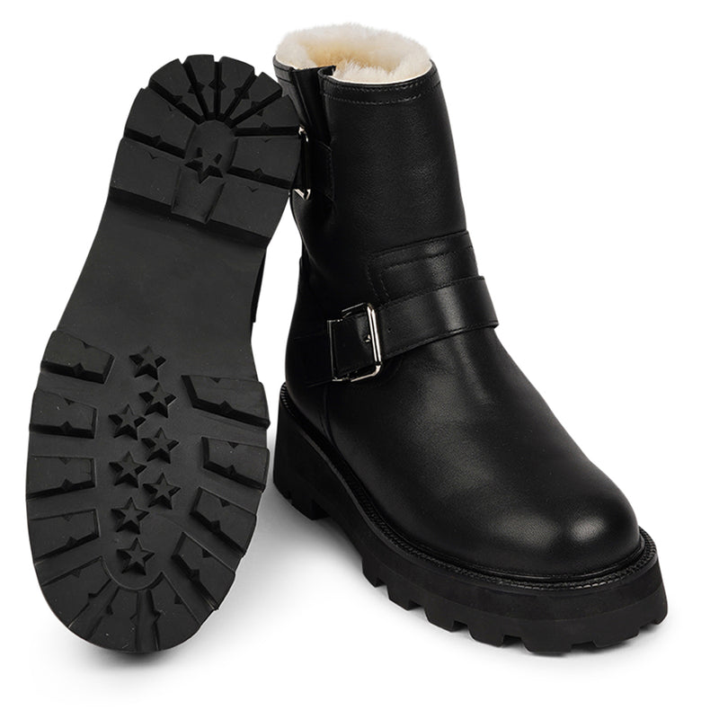 Lovelies Studio - Danish Design - Step into warmth and style this winter with our exquisite Dinara Winter Boot. Crafted to keep you snug and stylish through the coldest months.  The Dinara Winter Boot boasts a robust, thick rubber sole, providing superior traction and durability, so you can confidently navigate snowy streets and icy pathways. The upper is handcrafted in supple nappa leather.   Two adjustable buckles grace the boot's upper, allowing you to personalize the fit to your preference