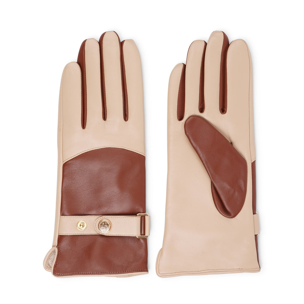 The Ferrara gloves are crafted from supple leather and lined with rich cashmere, offering warmth and lasting comfort. With their feminine silhouette, adjustable cuff strap, and choice of two colors, they blend timeless elegance with everyday practicality.