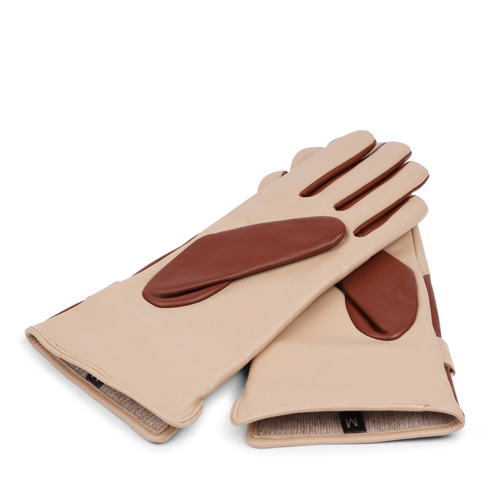 The Ferrara gloves are crafted from supple leather and lined with rich cashmere, offering warmth and lasting comfort. With their feminine silhouette, adjustable cuff strap, and choice of two colors, they blend timeless elegance with everyday practicality.