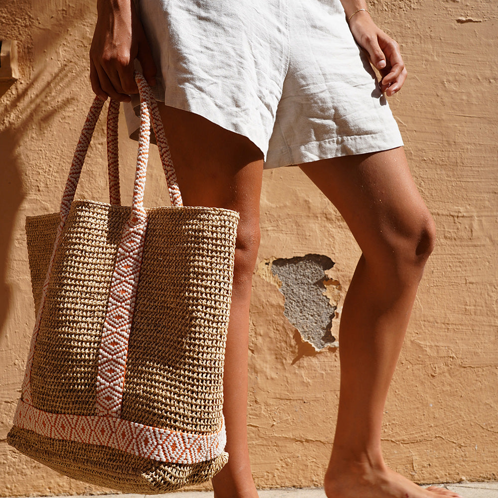 Raffia Carryall Bag

A stylish and practical carryall crafted from natural raffia in a warm, neutral tone. The bag features vibrant woven webbing straps that add a bold touch while providing strength and durability. Lightweight yet spacious, it’s perfect for beach days, market runs, or carrying your everyday essentials in effortless style.