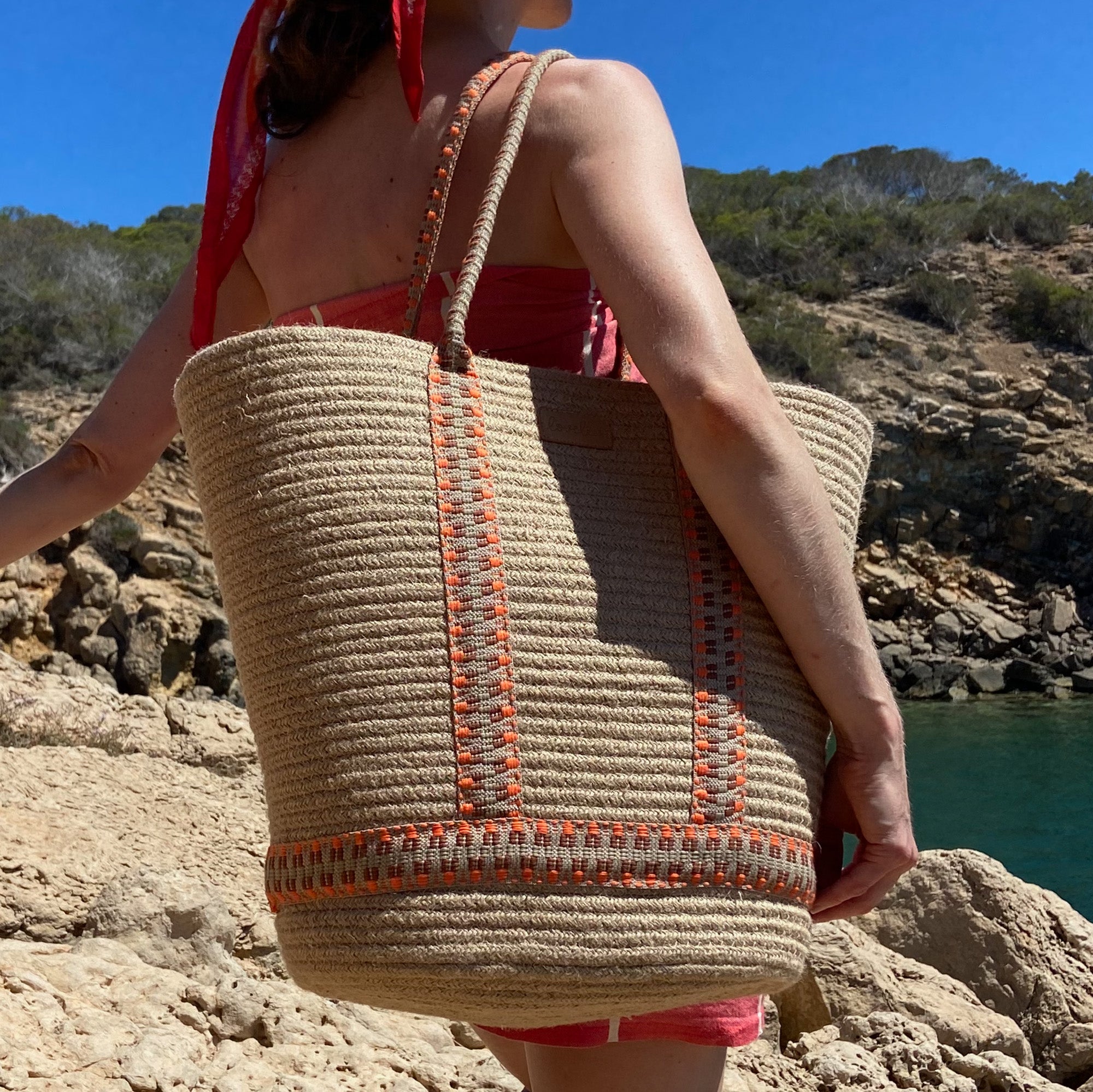 Lovelies - Woven Rope Carryall Bag

This chic and practical carryall seamlessly blends natural materials with a bold pop of pattern. Crafted from sturdy rope in a warm neutral tone, it features vibrant, eye-catching woven webbing straps that enhance both its style and structure. Lightweight yet spacious, this bag is perfect for beach days, market visits, or simply carrying your everyday essentials in style.