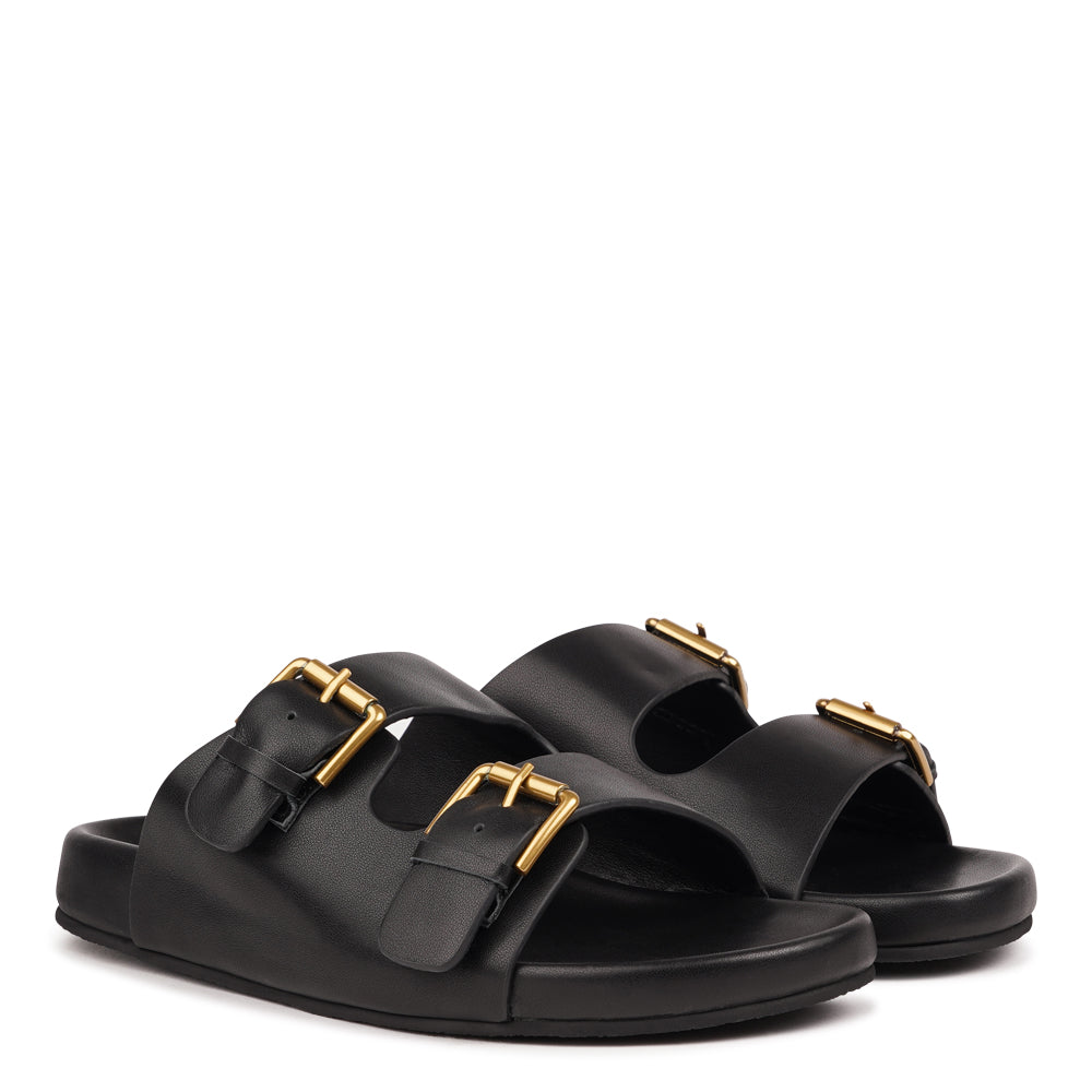 Effortlessly laid-back with a touch of understated luxury, these suede sandals are designed for all-day comfort and timeless appeal. Crafted from rich, soft leather, they feature two wide straps with adjustable silver-tone buckles for a customizable fit. The contoured footbed offers light support, while the flexible sole ensures ease of movement from indoors to out.