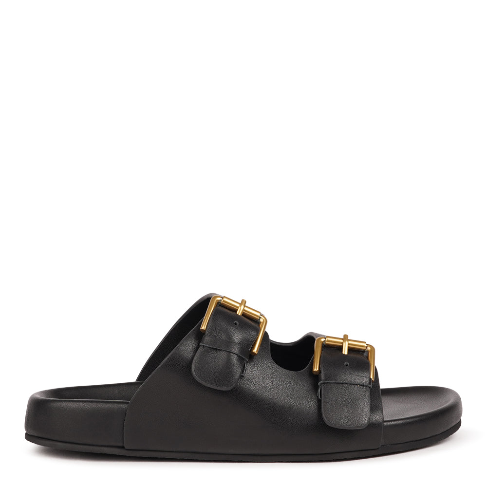 Effortlessly laid-back with a touch of understated luxury, these suede sandals are designed for all-day comfort and timeless appeal. Crafted from rich, soft leather, they feature two wide straps with adjustable silver-tone buckles for a customizable fit. The contoured footbed offers light support, while the flexible sole ensures ease of movement from indoors to out.