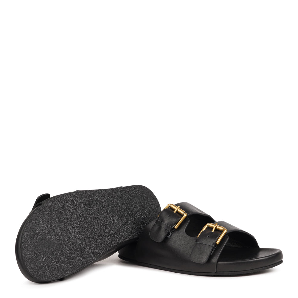 Effortlessly laid-back with a touch of understated luxury, these suede sandals are designed for all-day comfort and timeless appeal. Crafted from rich, soft leather, they feature two wide straps with adjustable silver-tone buckles for a customizable fit. The contoured footbed offers light support, while the flexible sole ensures ease of movement from indoors to out.