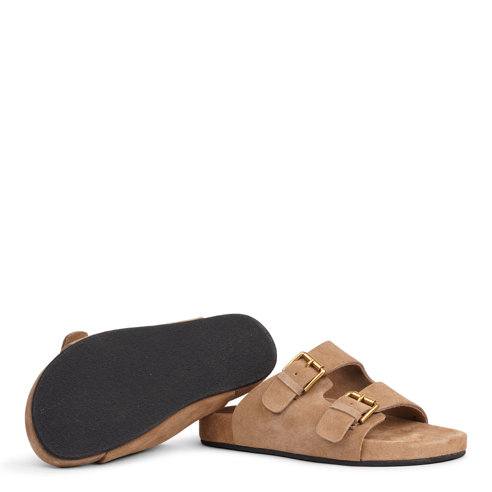 Lovelies Studio - Denmark - Effortlessly laid-back with a touch of understated luxury, these suede sandals are designed for all-day comfort and timeless appeal. Crafted from rich, soft suede, they feature two wide straps with adjustable gold-tone buckles for a customizable fit. The contoured footbed offers light support, while the flexible sole ensures ease of movement from indoors to out.
Perfect for casual days, warm getaways, or everyday lounging in style.