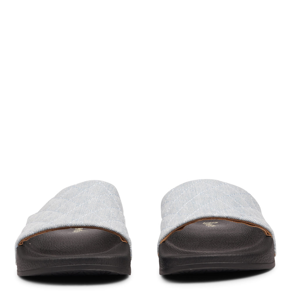 Crafted from quilted denim and featuring a butter-soft outsole, these slides are light, breezy, and effortlessly chic. Perfect for everyday wear, they bring comfort and style to any summer look.

Slip in and step out in style!