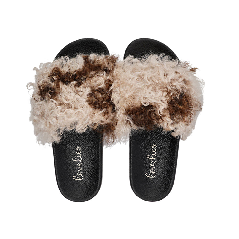 The Lennox Slide - a harmonious blend of comfort and elegance. These slides offer a touch of luxury for your feet, featuring naturally curly Tuscany shearling sourced from Australia.  The premium rubber sole ensures durability and excellent grip, making them versatile for indoor and outdoor wear. The shearling lining provides a cozy and comfortable experience, perfect for any season.