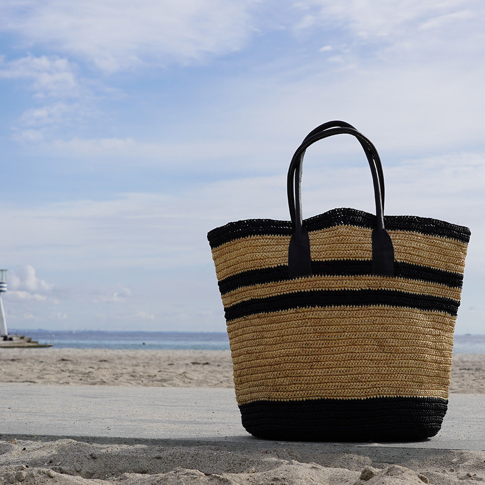 Lovelies - Effortlessly chic and naturally elegant, the Marini Large bag is your ideal companion for sunny days and relaxed escapes. Handwoven from 100% natural raffia by artisans in Madagascar, it blends timeless craftsmanship with modern versatility.

The textured raffia and earthy tones add laid-back sophistication to any look, while its lightweight design and comfortable shoulder handles make it perfect for beach days, market strolls, or weekend getaways.