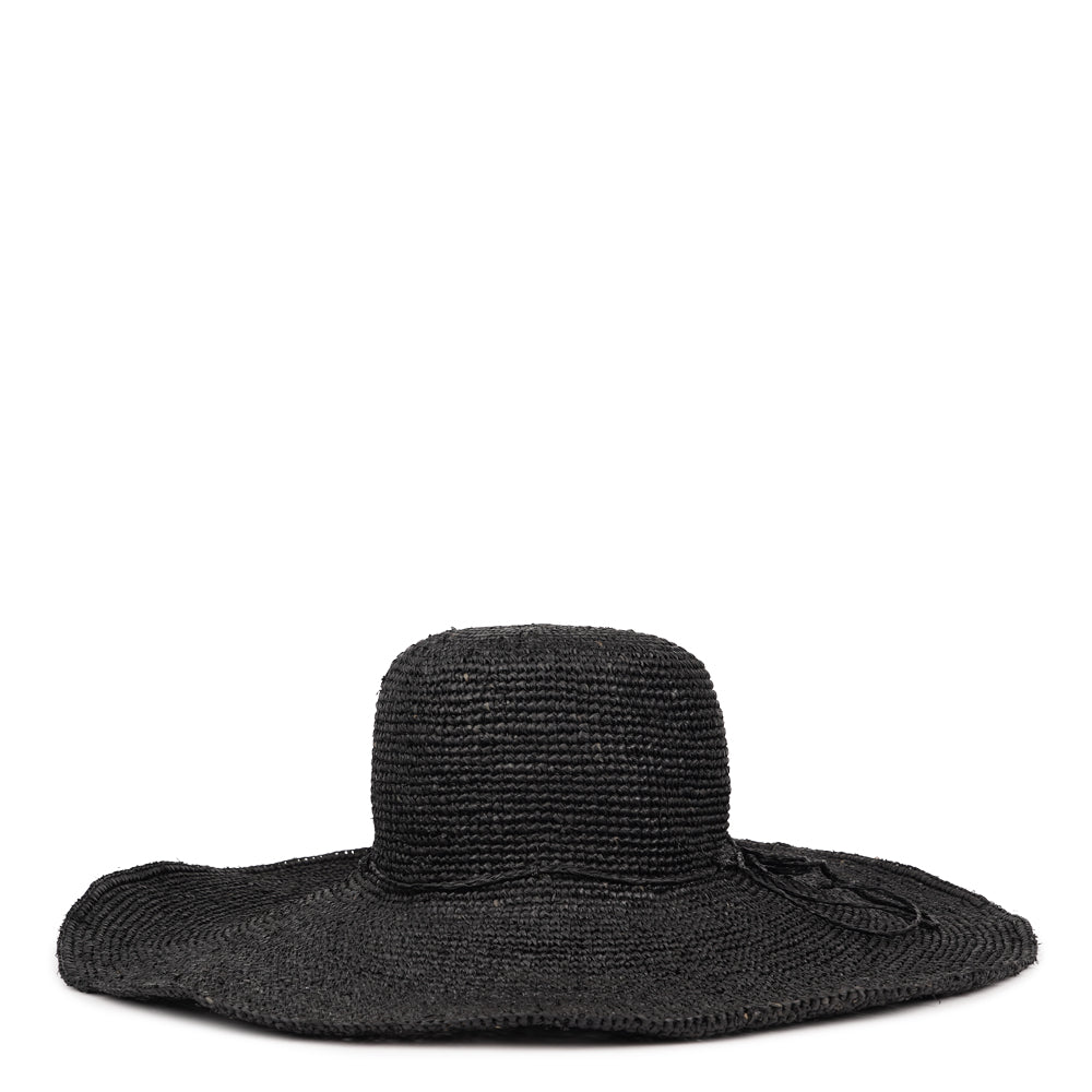 The Monti beach hat is a gorgeous piece, painstakingly crafted by talented local artisans in Madagascar, exclusively for Lovelies Studio. Each hat is a testament to the craftsmanship and devotion of these artisans, who meticulously handcraft every element with precision and care.

Crafted from raffia, a natural fiber celebrated for its strength and suppleness, the Monti hat embodies both style and sustainability. Utilizing traditional methods, the raffia is hand-dyed and left to bask in the sun.