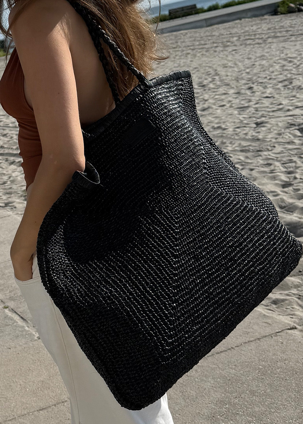 Raffia is a versatile and sustainable material that has become increasingly popular in the world of handbags. Derived from the leaves of the raffia palm tree, this natural fiber offers a unique blend of durability, flexibility, and eco-friendliness.

Handbags crafted from raffia exude a relaxed yet chic vibe, perfect for both casual outings and more formal occasions. The material's subtle texture and earthy tones add a touch of natural elegance to any ensemble, making it a favorite choice for fashion-forwar
