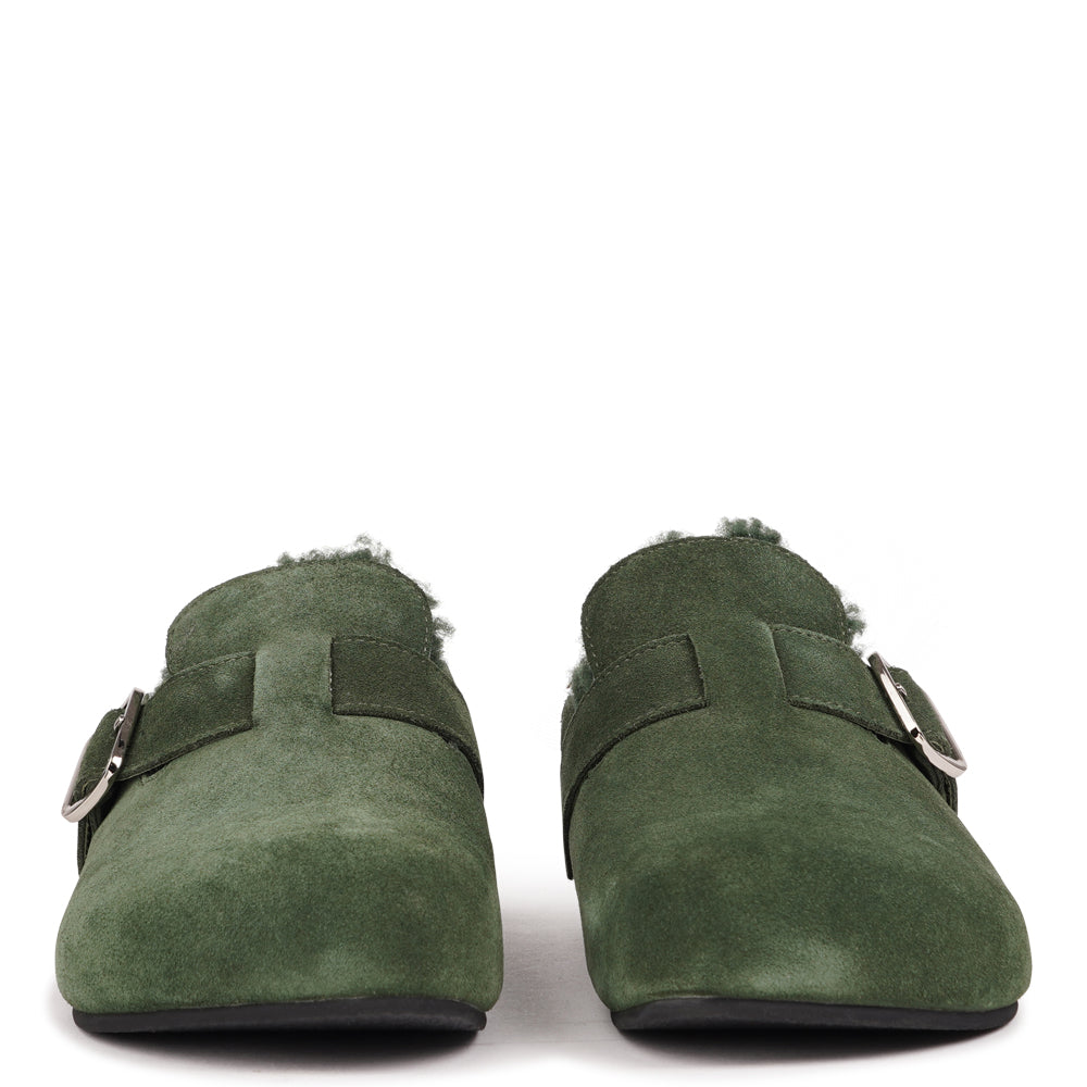 Lovelies Studio - The Nesso Suede Mules are the epitome of luxurious comfort and style. Crafted with a premium suede upper, these exclusive mules feature an adjustable buckle for a customized fit. Lined with soft curly shearling, they provide warmth and a cozy feel, perfect for cooler days.