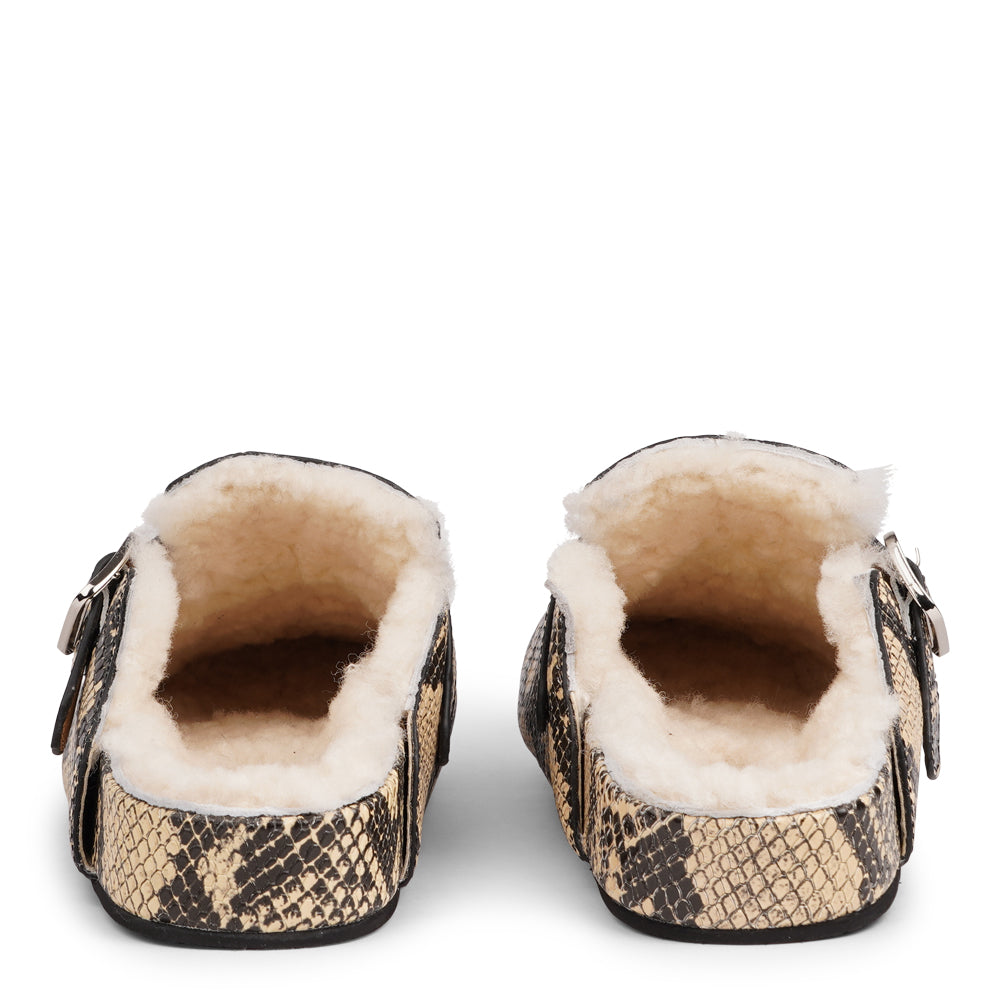 Lovelies Studio - The Nesso Snake Mules are the epitome of luxurious comfort and style. Crafted with a premium leather upper, these exclusive mules feature an adjustable buckle for a customized fit. Lined with soft curly shearling, they provide warmth and a cozy feel, perfect for cooler days.