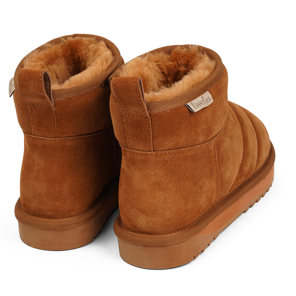 Lovelies - Ossa, Ossa, the epitome of cozy chic, is here to elevate your autumn and winter footwear game. These mid-high shearling boots are designed to envelop your feet in softness and warmth, making every step a delight.  Crafted with both comfort and durability in mind, Ossa boasts a soft and resilient rubber sole that's perfect for tackling wintery conditions. And let's not forget the exquisite design that complements your style effortlessly, ensuring you're fashionably prepared for the season ahead.