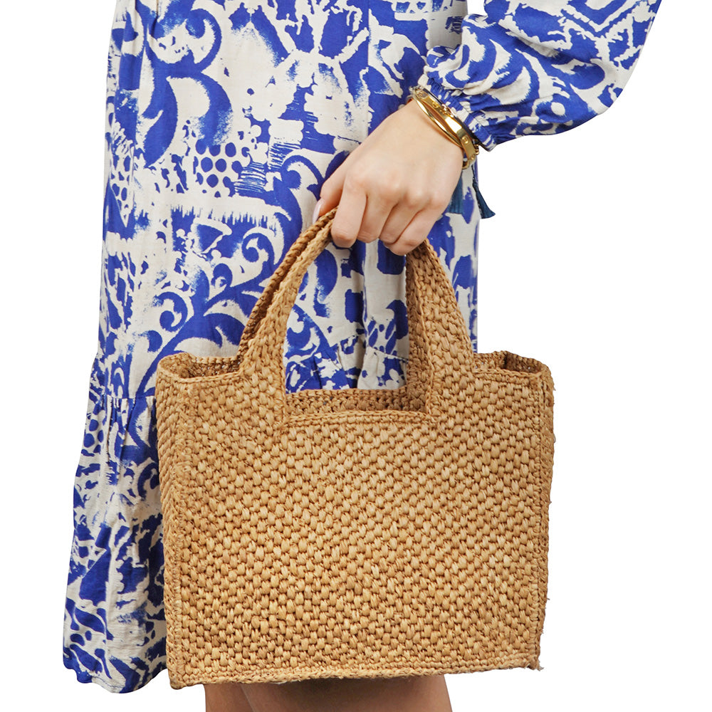 Lovelies - Effortlessly chic and naturally elegant, the Rivabella bag is your go-to accessory for sun-soaked days and breezy evenings. Handwoven from 100% raffia by skilled artisans in Madagascar, this compact yet spacious bag blends timeless craftsmanship with modern simplicity.

The raffia’s rich texture and earthy tone add a relaxed sophistication to any look—perfect for everything from a city stroll to a summer soirée. Lightweight yet durable, Rivabella is designed to accompany you all day with ease. Th