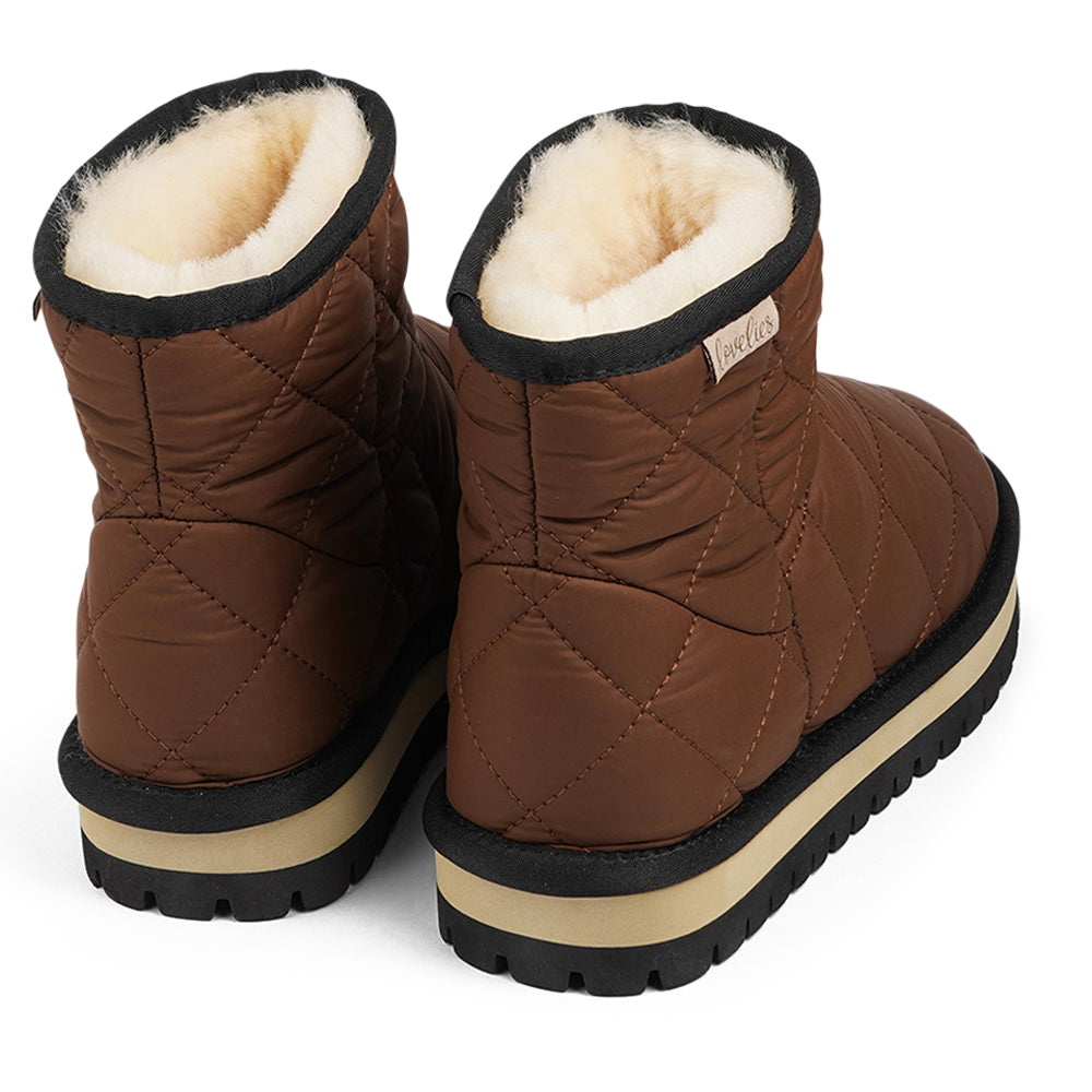 Designed to keep your feet cozy and stylish all autumn long. Experience ultimate softness and warmth as the luxurious shearling lining wraps your feet in comfort.  With their soft and durable rubber soles, these boots provide a perfect combination of flexibility and durability, making them ideal for the wintertime. No need to worry about wet weather – the quilted nylon material is water-resistant, keeping your feet dry and comfortable even on rainy days.