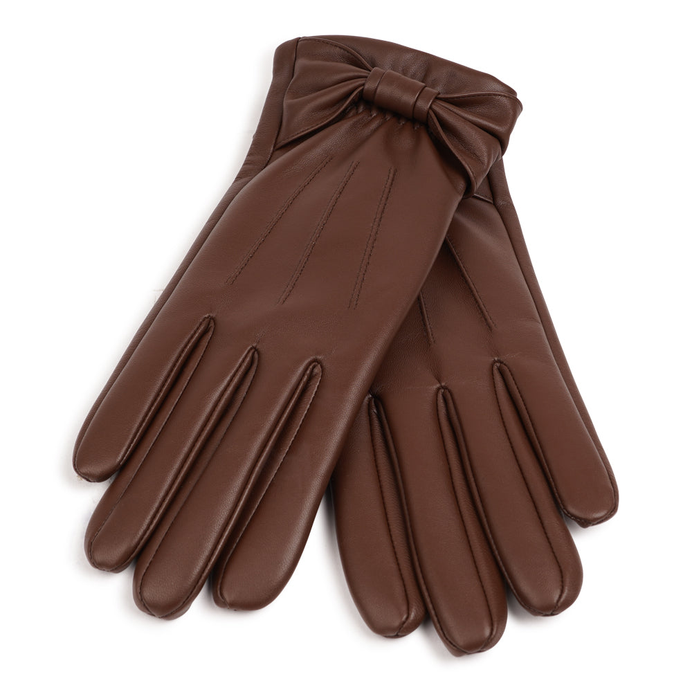 Lovelies Studio - The Sondrio gloves are a refined blend of style and luxury, crafted from supple lambskin and adorned with a charming bow detail. Lined with soft cashmere, these gloves provide exceptional warmth and comfort.

Their elegant design and sophisticated touch make Sondrio a perfect accessory for adding a bit of glamour to your winter wardrobe.