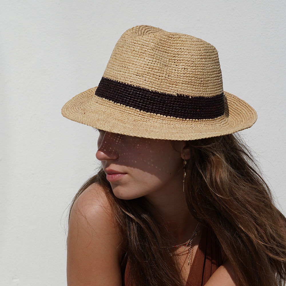 Lovelies Studio - What truly sets the Viviani hat apart is its intricate weaving technique, which transforms the raffia into a timeless <span data-mce-fragment="1">fedora</span> silhouette. The result is a beautifully structured hat that effortlessly combines elegance with a touch of rustic charm, perfect for adding a chic flair to any summer ensemble
