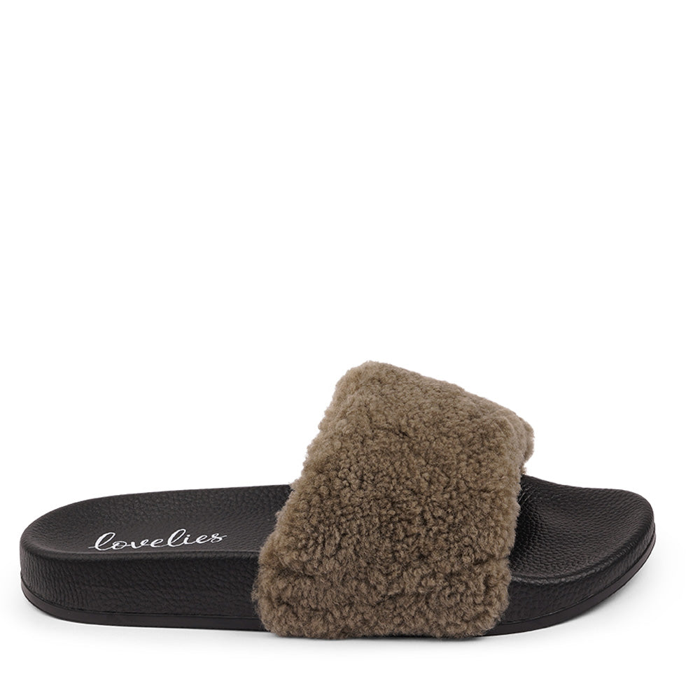 Slides with Australian Shearling upper.  This wonderful slide has a soft and light rubber sole which makes it very comfortable and an all time favorite sandal. The 100% shearling wool will keep you warm or cool you down on hot summer days.