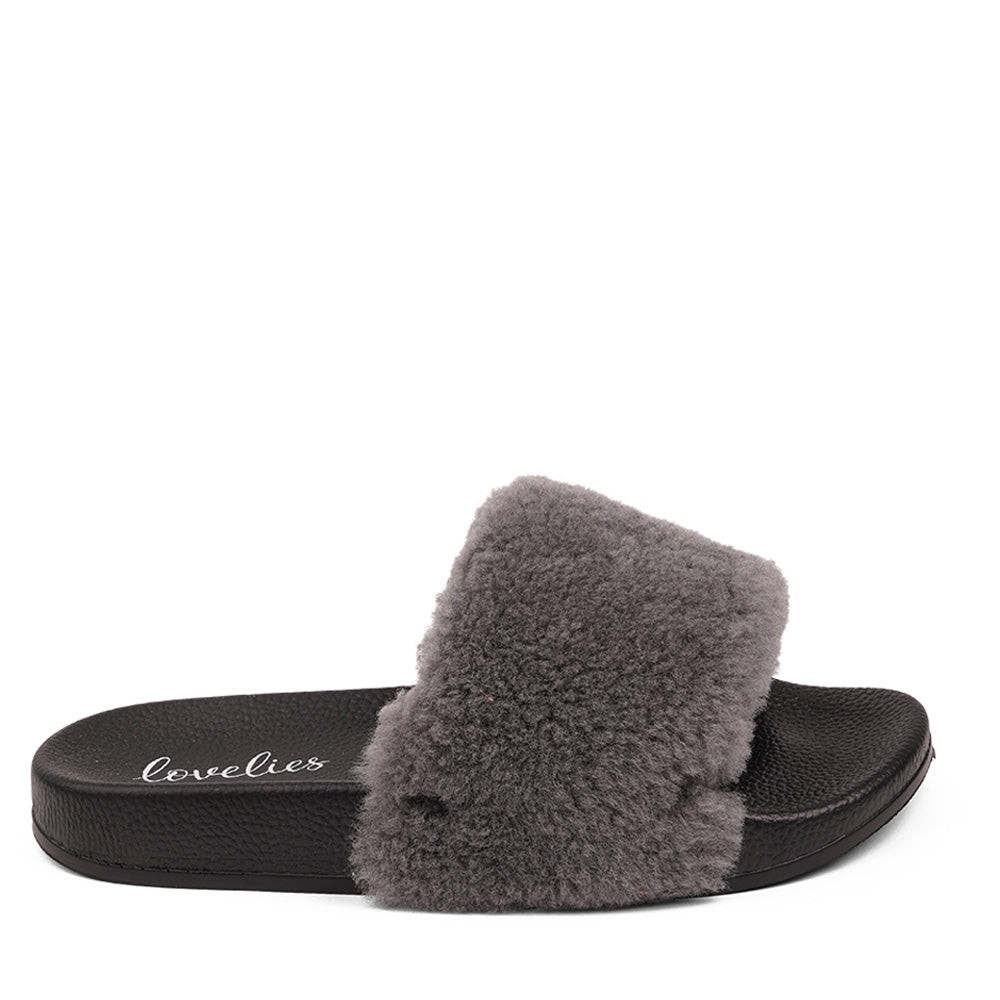 Slides with Australian Shearling upper.  This wonderful slide has a soft and light rubber sole which makes it very comfortable and an all time favorite sandal. The 100% shearling wool will keep you warm or cool you down on hot summer days.