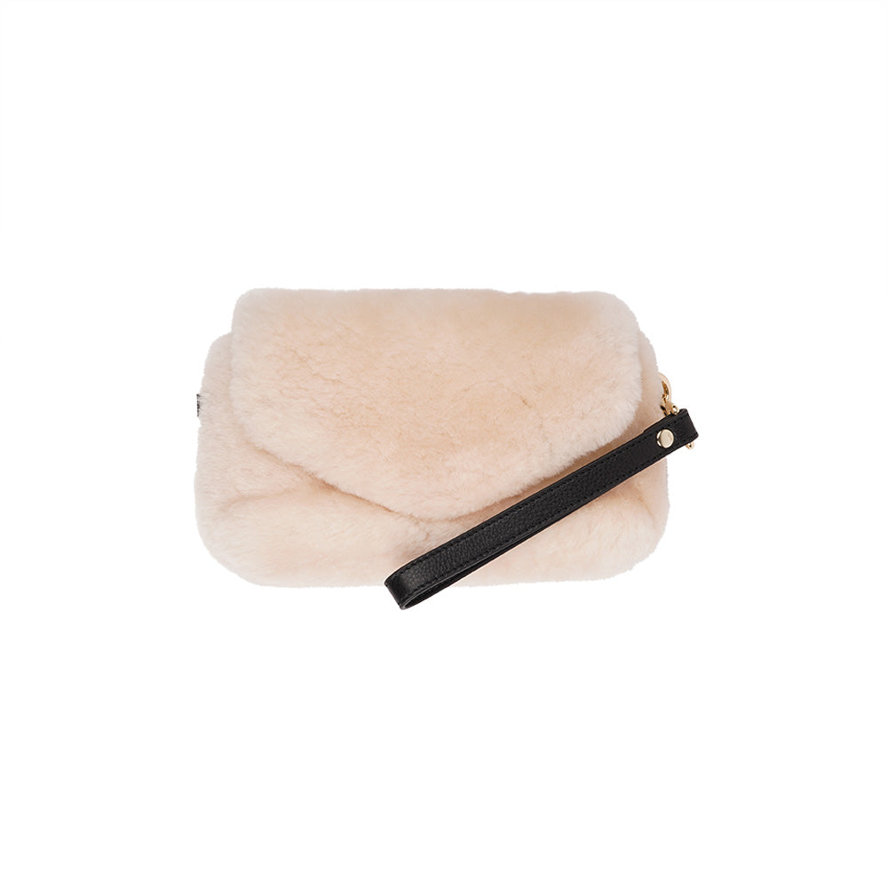 Lovelies Studio Understated and elegant, the little sister Corso shearling clutch with detachable crossbody strap comes in both black and cream. Corso is perfect for carrying your essentials with you for party or everyday use. Front flap with hidden magnetic fastening.   Adjustable and detachable wrist strap. Adjustable and detachable shoulder strap in leather. Shoulder strap 105 cm and 15 mm wide. Lining of suede and soft skin.  Flat zipped inner pocket.  Embossed Lovelies logo inside the bag 