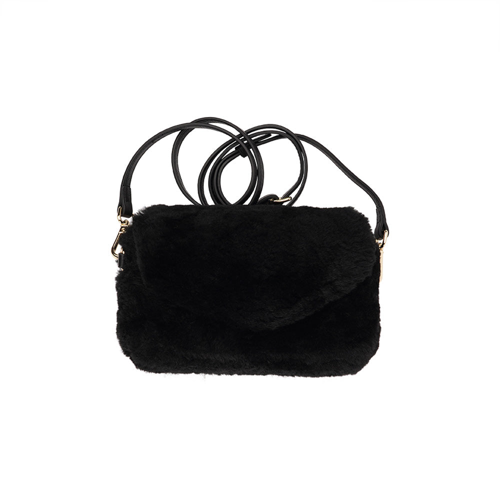 Lovelies Studio Understated and elegant, the little sister Corso shearling clutch with detachable crossbody strap comes in both black and cream. Corso is perfect for carrying your essentials with you for party or everyday use. Front flap with hidden magnetic fastening.   Adjustable and detachable wrist strap. Adjustable and detachable shoulder strap in leather. Shoulder strap 105 cm and 15 mm wide. Lining of suede and soft skin.  Flat zipped inner pocket.  Embossed Lovelies logo inside the bag 