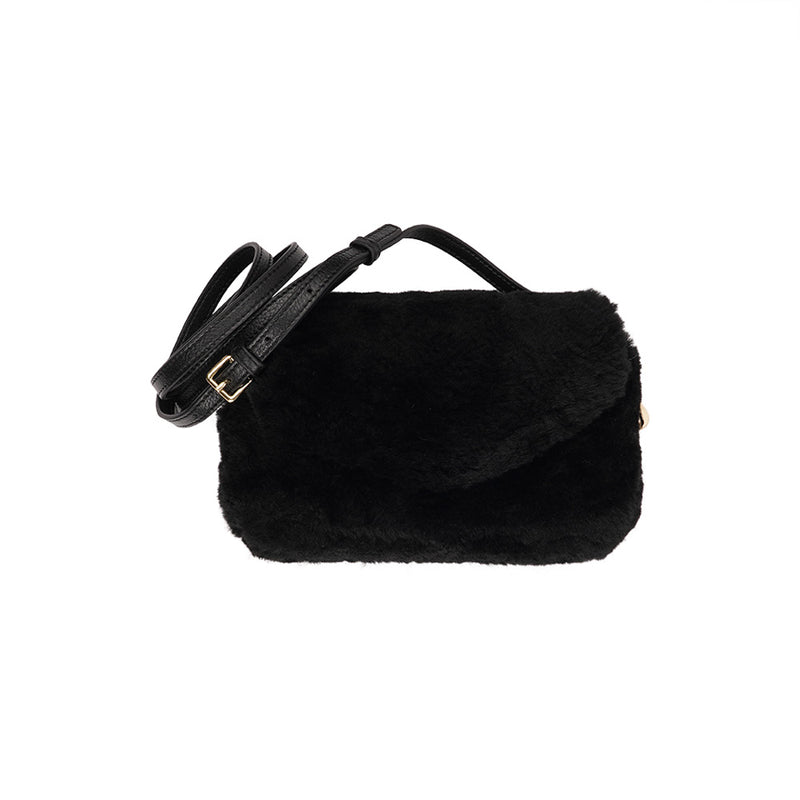 Lovelies Studio Understated and elegant, the little sister Corso shearling clutch with detachable crossbody strap comes in both black and cream. Corso is perfect for carrying your essentials with you for party or everyday use. Front flap with hidden magnetic fastening.   Adjustable and detachable wrist strap. Adjustable and detachable shoulder strap in leather. Shoulder strap 105 cm and 15 mm wide. Lining of suede and soft skin.  Flat zipped inner pocket.  Embossed Lovelies logo inside the bag 
