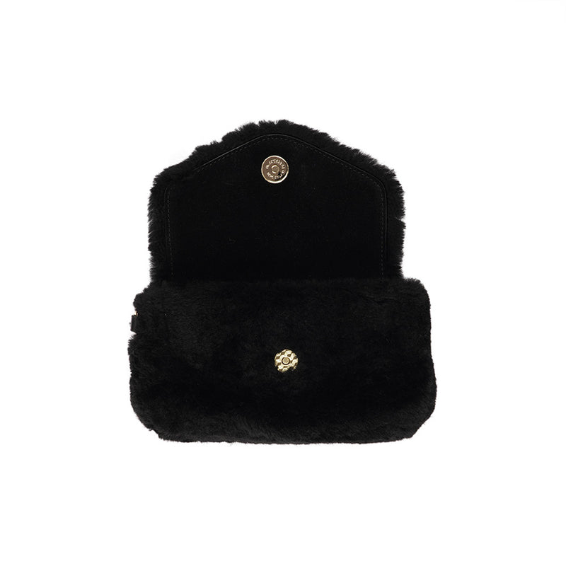 Lovelies Studio Understated and elegant, the little sister Corso shearling clutch with detachable crossbody strap comes in both black and cream. Corso is perfect for carrying your essentials with you for party or everyday use. Front flap with hidden magnetic fastening.   Adjustable and detachable wrist strap. Adjustable and detachable shoulder strap in leather. Shoulder strap 105 cm and 15 mm wide. Lining of suede and soft skin.  Flat zipped inner pocket.  Embossed Lovelies logo inside the bag 