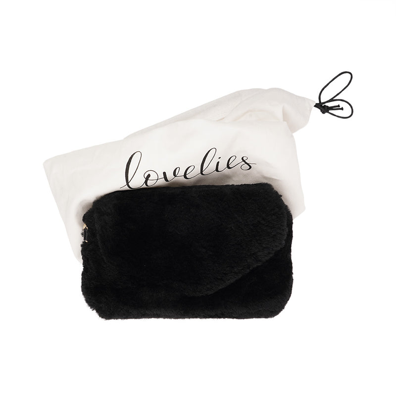 Lovelies Studio Understated and elegant, the little sister Corso shearling clutch with detachable crossbody strap comes in both black and cream. Corso is perfect for carrying your essentials with you for party or everyday use. Front flap with hidden magnetic fastening.   Adjustable and detachable wrist strap. Adjustable and detachable shoulder strap in leather. Shoulder strap 105 cm and 15 mm wide. Lining of suede and soft skin.  Flat zipped inner pocket.  Embossed Lovelies logo inside the bag 