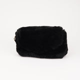 Understated and elegant, the little sister Corso shearling clutch with detachable crossbody strap comes in both black and cream. Corso is perfect for carrying your essentials with you for party or everyday use.   * Front flap with hidden magnetic fastening   * Adjustable and detachable wrist strap   * Adjustable and detachable shoulder strap in leather * Shoulder strap 105 cm and 15 mm wide   * Lining of suede and soft skin.   * Flat zipped inner pocket   * Embossed Lovelies logo inside the bag 