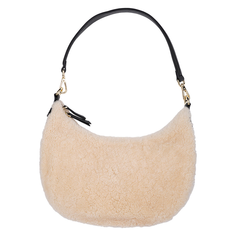 Kangmar is a beautiful shearling handbag which is perfect for carrying your essentials with you, it comes with detachable shoulder strap in skin. Top double zipped closure. Top handle in soft skin with hardware in gold. Adjustable and detachable shoulder strap in leather, 15 mm wide.  Satin lining and flat zipped inner pocket Item comes with a branded dust bag. Embossed Lovelies logo inside the bag.  Gold-toned hardware Measurements W36 X D5 X H20 cm 100 % Australian shearling 