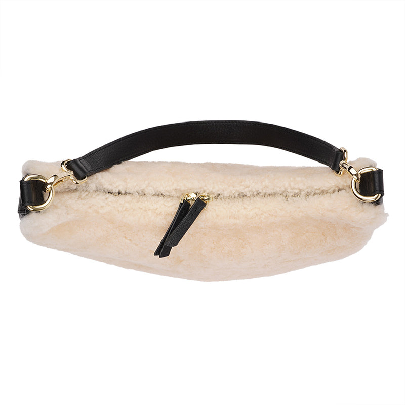 Kangmar is a beautiful shearling handbag which is perfect for carrying your essentials with you, it comes with detachable shoulder strap in skin. Top double zipped closure. Top handle in soft skin with hardware in gold. Adjustable and detachable shoulder strap in leather, 15 mm wide.  Satin lining and flat zipped inner pocket Item comes with a branded dust bag. Embossed Lovelies logo inside the bag.  Gold-toned hardware Measurements W36 X D5 X H20 cm 100 % Australian shearling 
