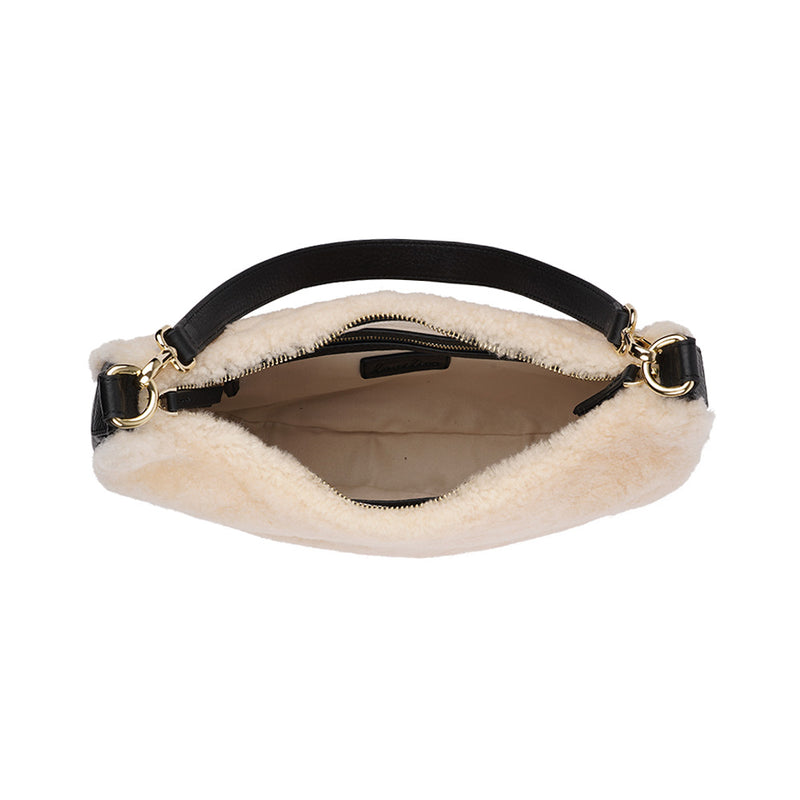Kangmar is a beautiful shearling handbag which is perfect for carrying your essentials with you, it comes with detachable shoulder strap in skin. Top double zipped closure. Top handle in soft skin with hardware in gold. Adjustable and detachable shoulder strap in leather, 15 mm wide.  Satin lining and flat zipped inner pocket Item comes with a branded dust bag. Embossed Lovelies logo inside the bag.  Gold-toned hardware Measurements W36 X D5 X H20 cm 100 % Australian shearling 